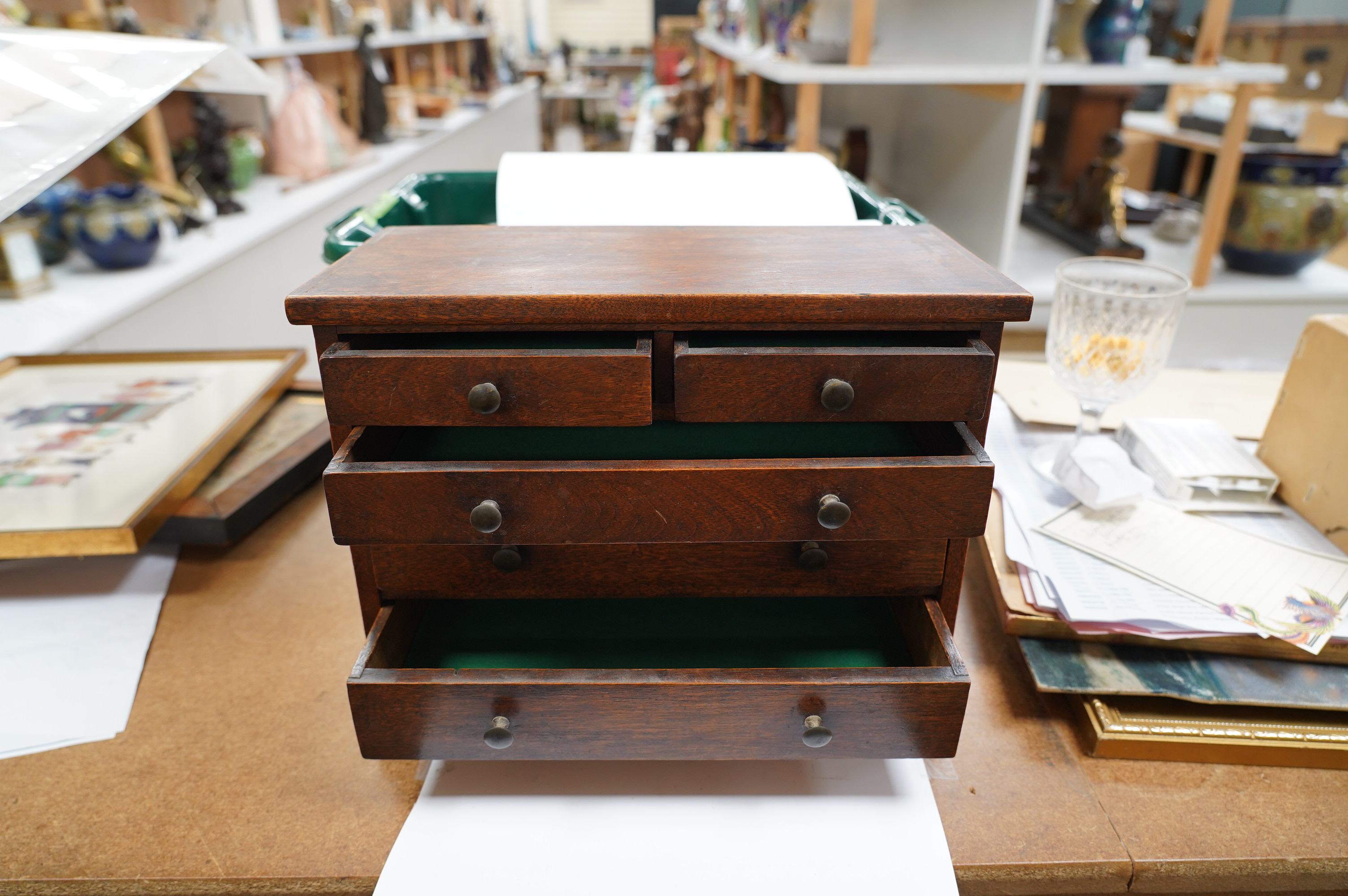 A miniature mahogany three long, two short, chest of drawers 32cms wide. Condition - good